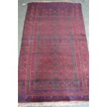 Belouch rug with an all-over stylised design on a dark ground with multiple border, 173cms x 103cms