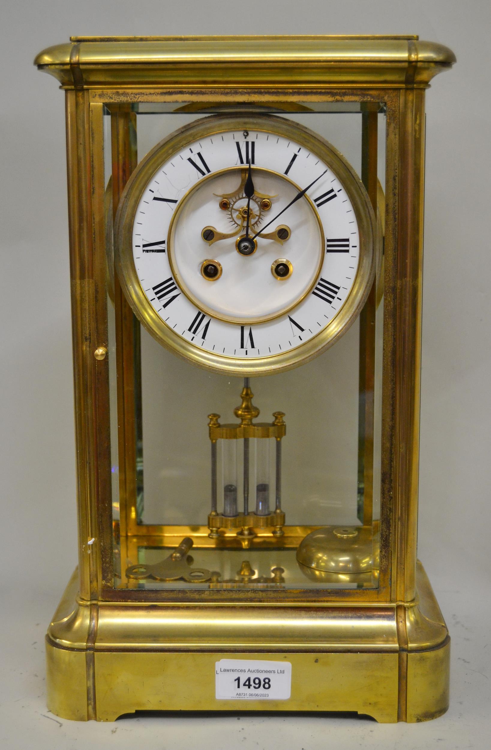 Large late 19th / early 20th Century French gilt brass four glass library clock, the enamel dial