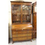 Regency mahogany and black line inlaid cylinder bureau bookcase, the moulded cornice above a pair of