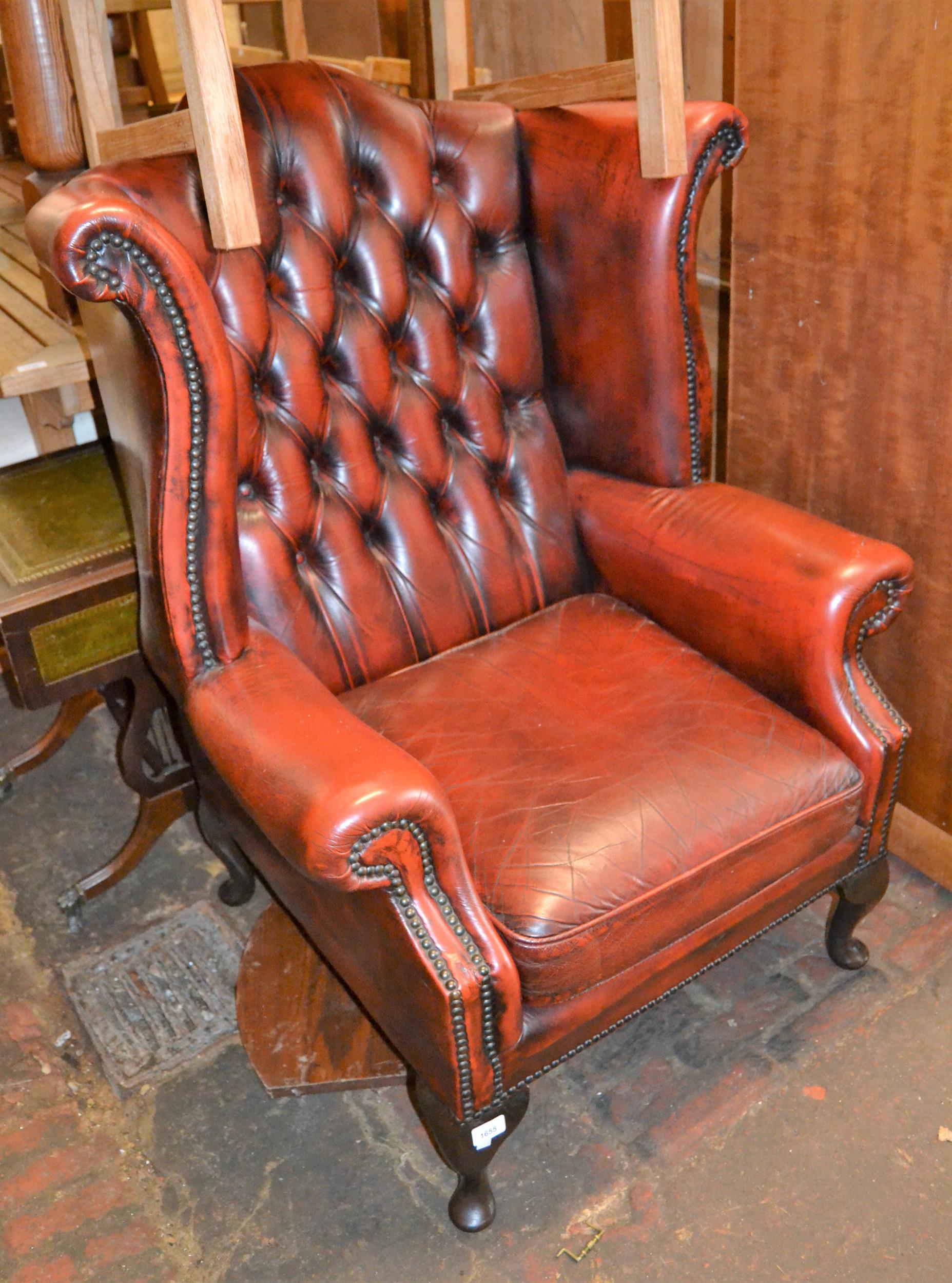 20th Century red leather and button upholstered wing back armchair on cabriole supports (with