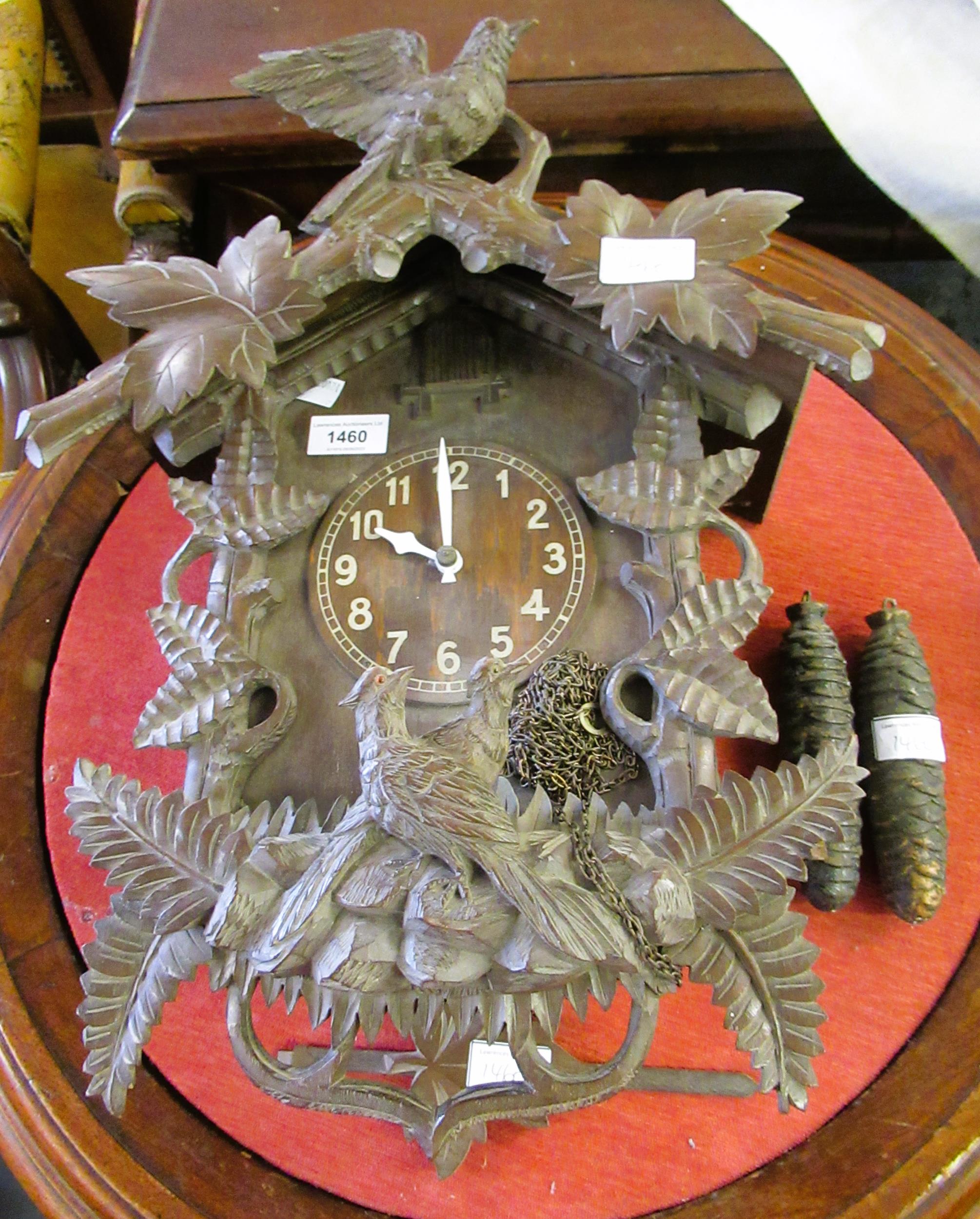 20th Century Black Forest carved cuckoo clock with a two train weight driven movement, 41cms high