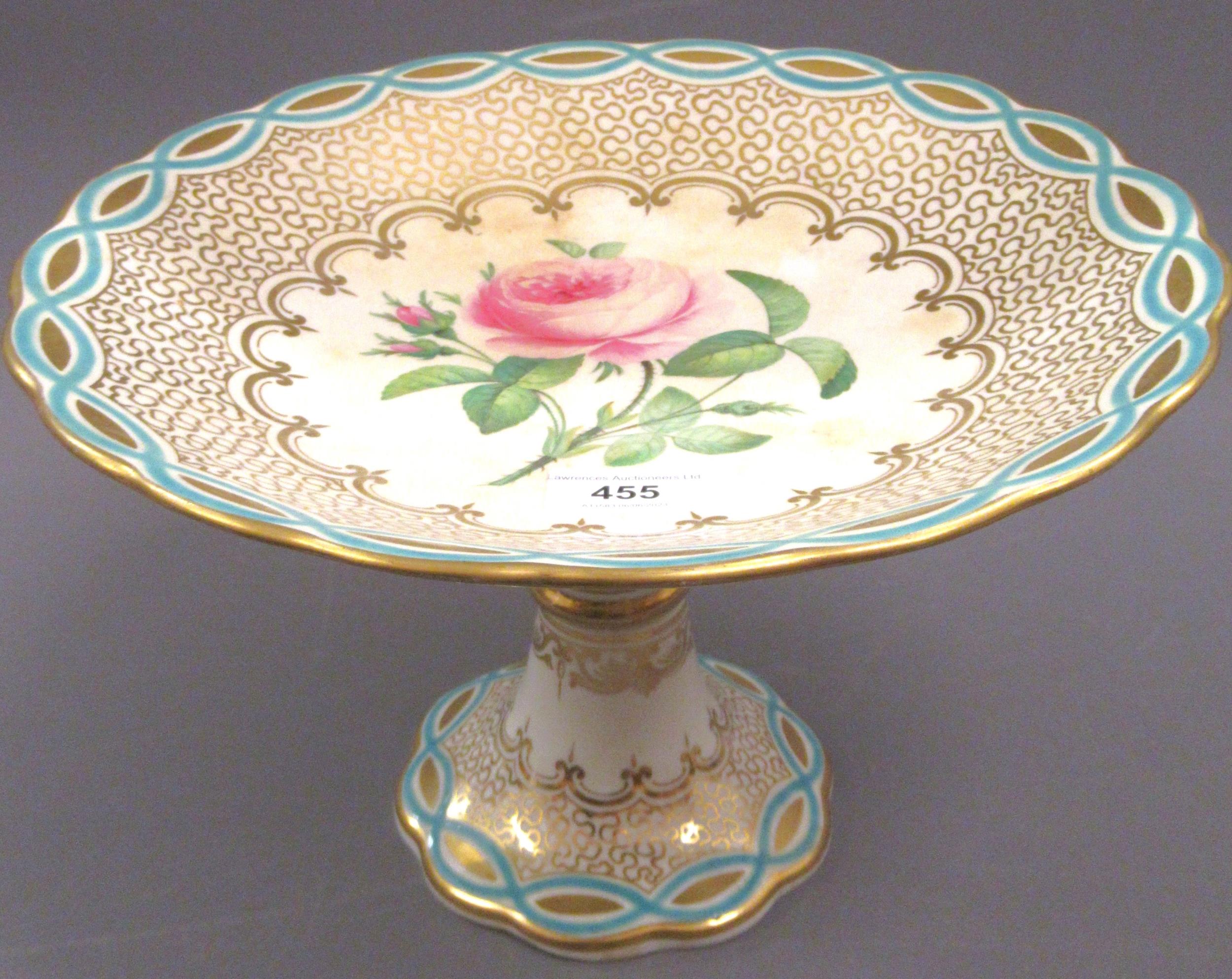 19th Century English porcelain tazza painted with a rose within a blue and gilt border, 28cms