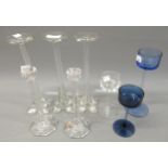 Three Wedgwood glass candle stands in clear and blue glass, 14cms and 20cms high, together with a