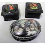 Two modern Russian papier mache boxes having hinged covers decorated with figures, signed,