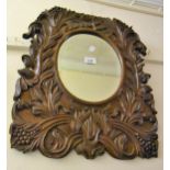 Floral carved oak wall mirror (at fault), 54cms x 46cms Split to top of mirror