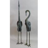 Pair of large green patinated bronze garden figures of cranes, the tallest 191cms