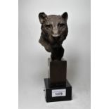 Brown patinated bronze leopard's head mounted on stepped base, bearing signature, P.J. Mene 25cms