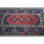 Modern Turkish rug with a triple medallion design in shades of red and blue, 204cms x 121cms