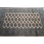 Pakistan rug of Turkoman design with three rows of gold on a beige ground with borders, 186cms x