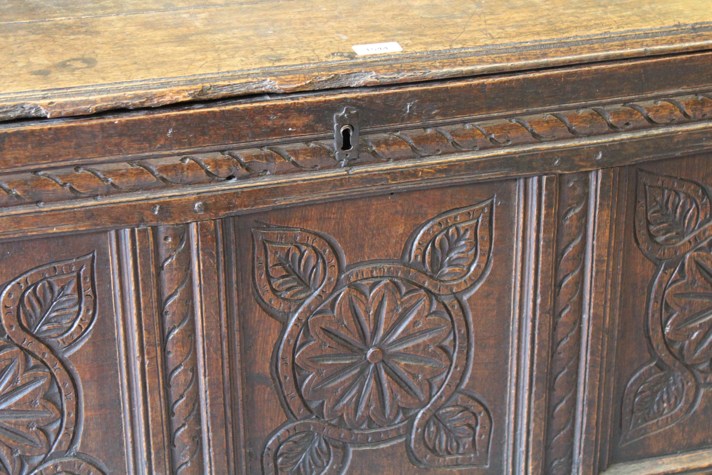 17th Century oak coffer, the moulded hinged top above carved three panel front on stile supports, - Image 2 of 2