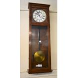 Early 20th Century walnut cased Vienna type wall clock, the rectangular case enclosing an enamel