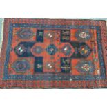 Kurdish rug with a large centre medallion and subsidiary hooked medallion motifs in shades of