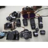 Two SLR cameras by Canon and Olympus, three Russian cameras, quantity of accessories and a pair of