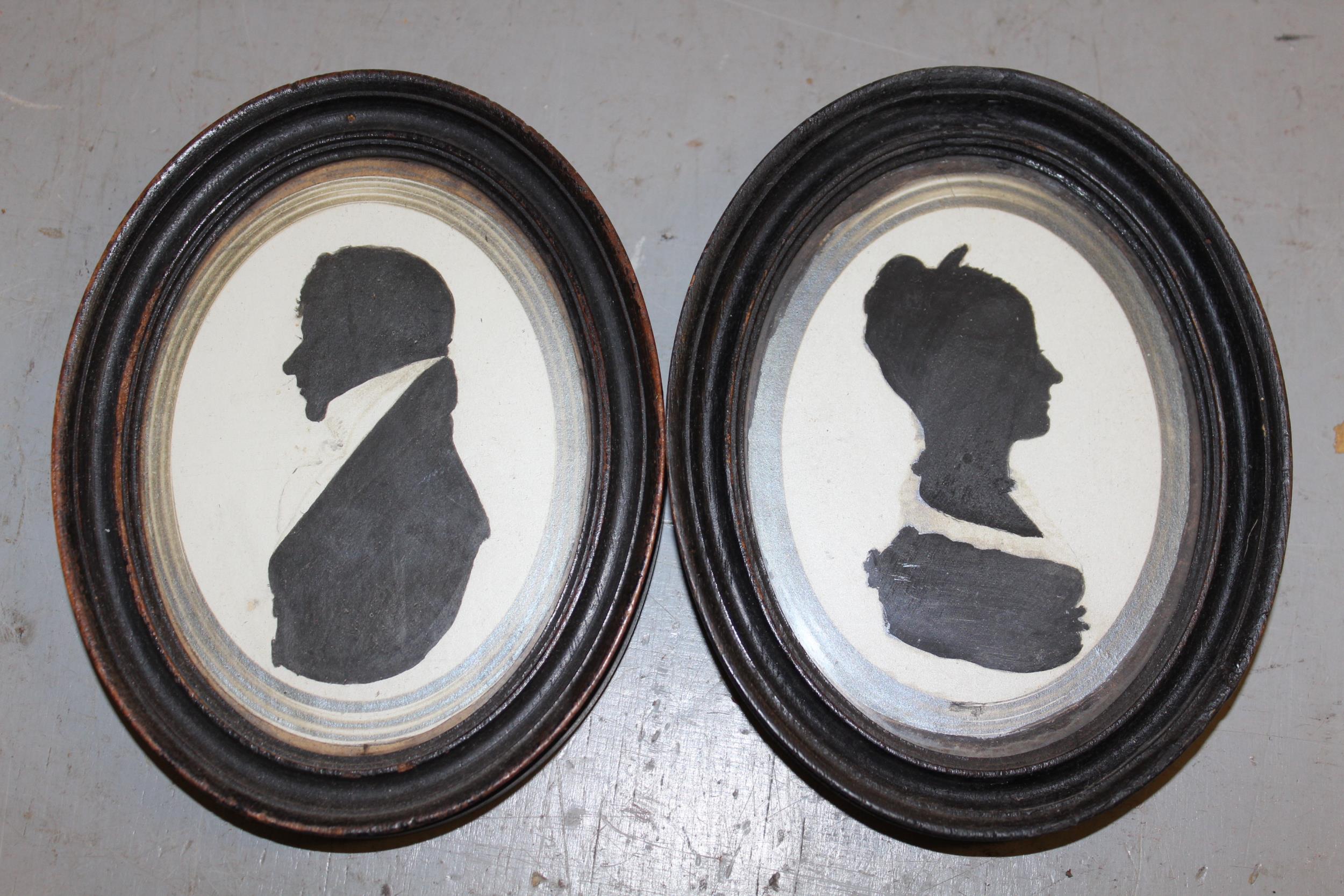 Two pairs of 19th Century silhouette portraits of ladies and gentlemen, together with another