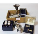 Two pairs of silver taper sticks, (one boxed), four silver napkin rings, two silver frames, a bud