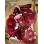 Box containing a collection of various cranberry glassware including bowls, vases, decanters etc.