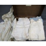Suitcase containing a quantity of early and late 19th Century clothing including dresses,