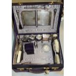 Extensive leather dressing case containing a large quantity of silver and silver mounted cut glass