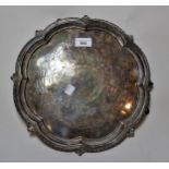 Silver plated circular salver with pierced and cast rim, on low supports with engraved decoration