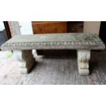Weathered cast concrete garden bench, the slab top on two moulded upright supports