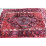 Hamadan rug with a lobed medallion and all-over Herati design in shades of predominantly red and