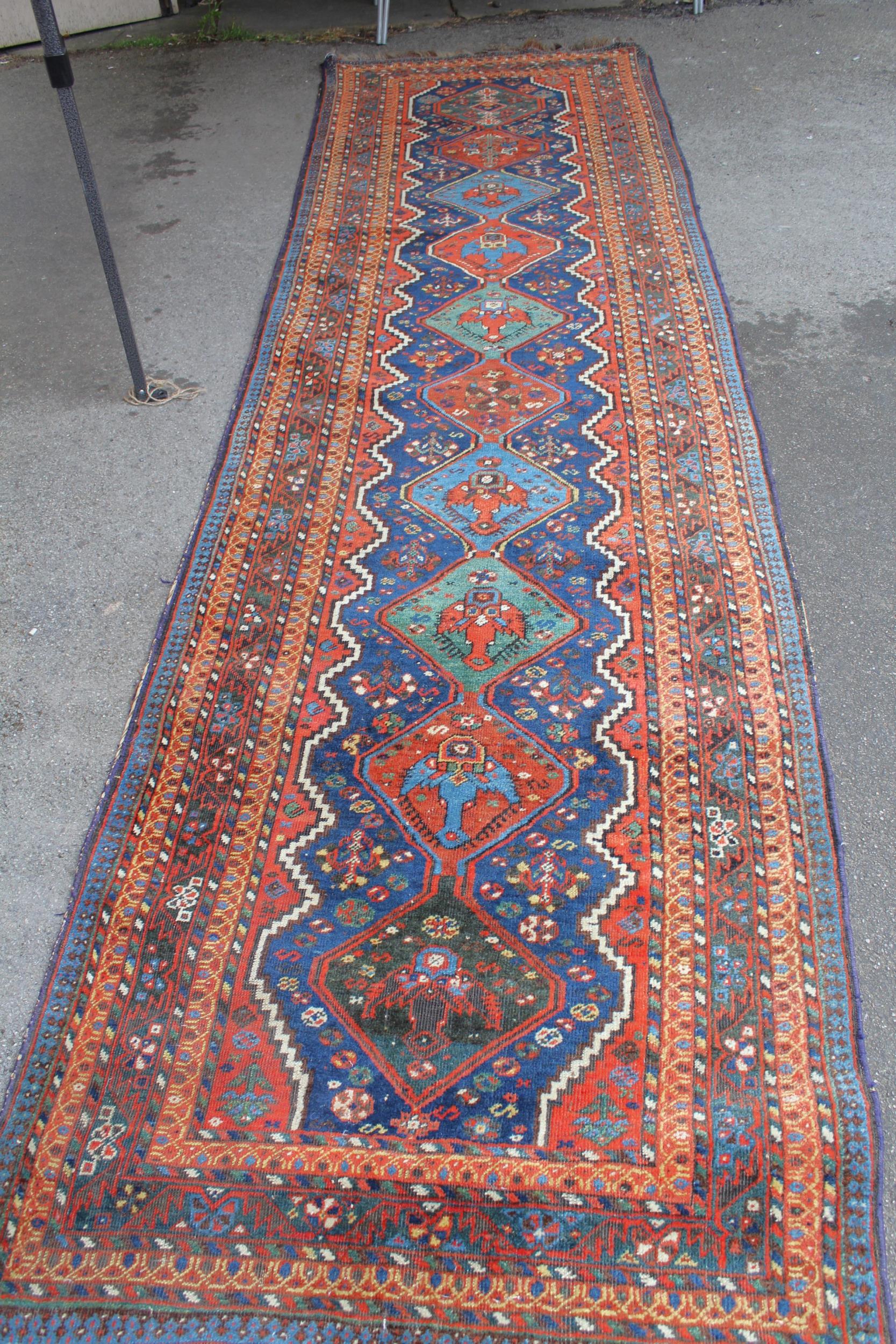 Afshar runner with a repeating polychrome pole medallion design on a midnight blue ground with