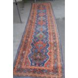 Afshar runner with a repeating polychrome pole medallion design on a midnight blue ground with