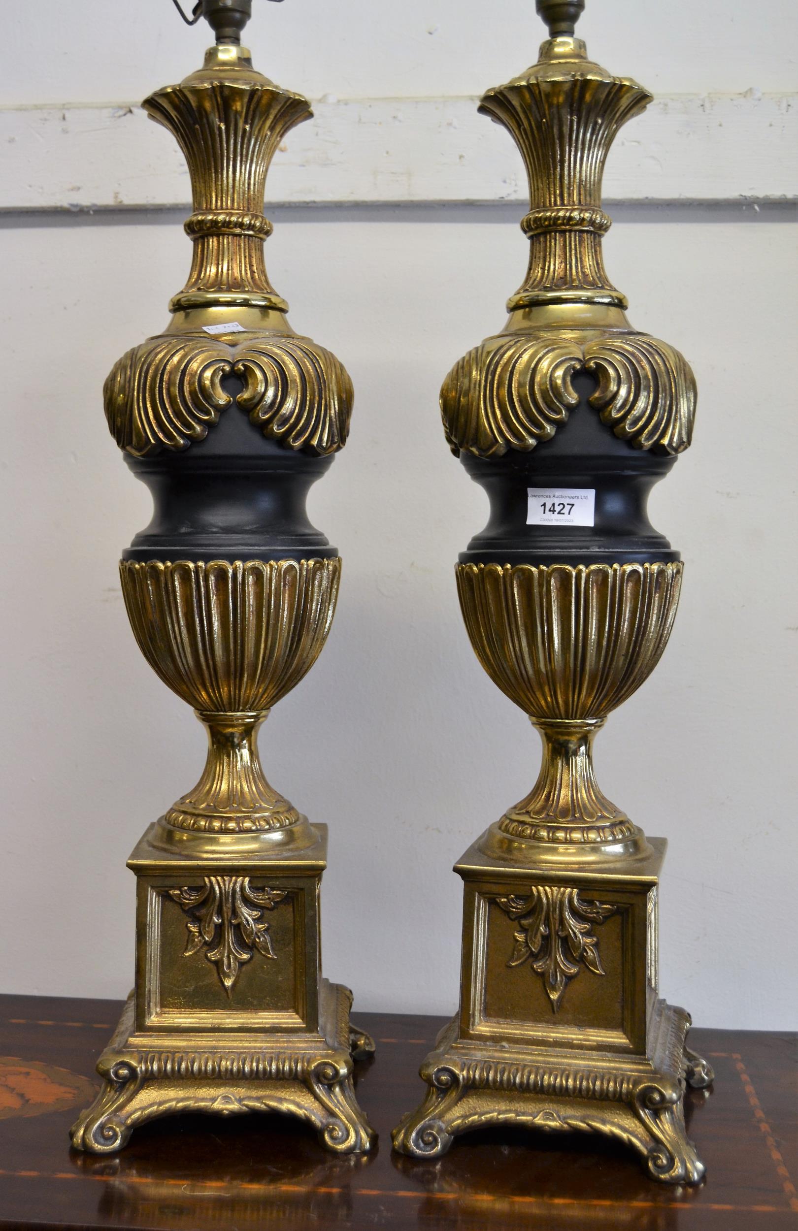 Pair of large cast gilded brass and black patinated table lamps, 68cms high Are a little loose,