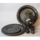 Antique pewter plate, another smaller, three measures, another dish and a pewter lidded jug
