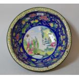 Large Chinese Canton enamel bowl, decorated with various flowers, fruit and figures in landscapes (