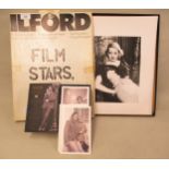 Photographic box containing a quantity of 12in x 16in photographs of film stars and a James Bond box