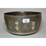 Large white metal bowl, having all-over embossed and chased decoration, the side walls decorated