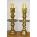 Pair of large brass baluster form candlesticks with wide drip trays, 67.5cms high