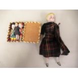 Three miniature bisque dolls, together with another bisque doll in Scottish costume Vosper 255
