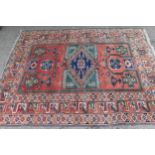 20th Century Kazak rug with a medallion and all-over stylised design on a red ground with multiple