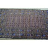 Modern Belouch rug with an all-over stylised flower head design in rectangular centre panel, with