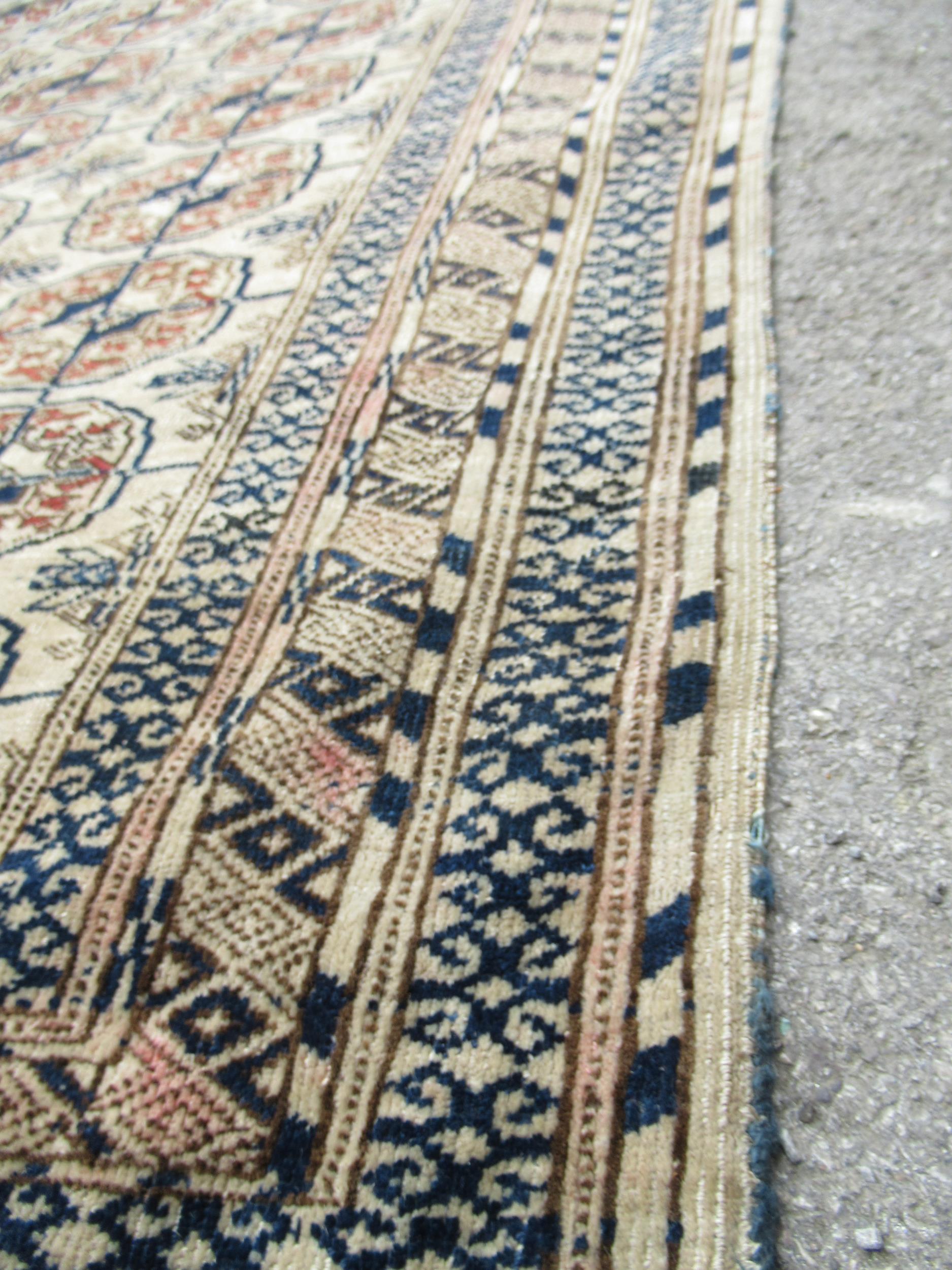 Turkoman rug, the three rows of gols and multiple borders on a washed beige, red and blue ground, - Image 5 of 21