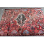 Navahand rug with a medallion and all-over stylised floral design on a red ground (ends cut), 160cms