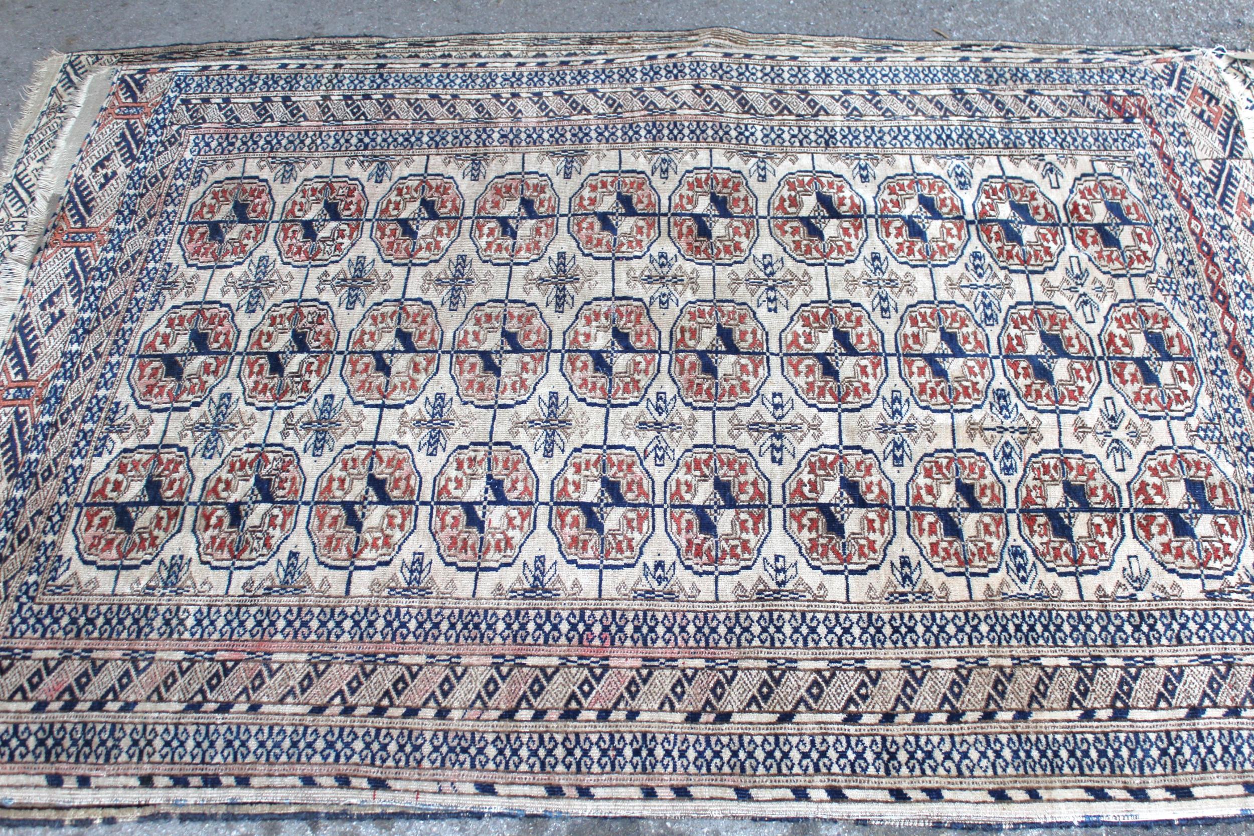 Turkoman rug, the three rows of gols and multiple borders on a washed beige, red and blue ground, - Image 2 of 21
