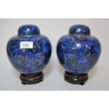 Pair of modern cloisonne ginger jars having floral decoration with a blue ground, with hardwood