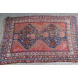 Small Shiraz rug with a twin gol medallion on red ground with borders, 145cms x 95cms