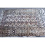 Turkoman rug, the three rows of gols and multiple borders on a washed beige, red and blue ground,