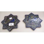 Two Persian terracotta star form tiles decorated with flowers and birds