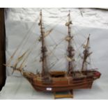 Wooden model of a three masted ship on wooden stand, 72 x 87cms wide