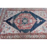 Antique Kurdish rug with a lobed medallion design in shades of red, blue and beige (some wear)