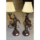 Pair of French brown patinated spelter table lamps in the form of warriors after Picault, 51cms high