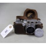 Leica camera in original leather case, No. 428904 Has manual zoom and aperture adjustment.