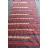 Kelim rug with a polychrome banded design, 270cms x 133cms approximately (repairs and damages)