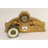 Art Deco gold painted metal mantel clock mounted with two figures of mountain lions, 32cms wide