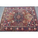 Tabriz rug with a central medallion and all-over floral design with red ground and floral borders,